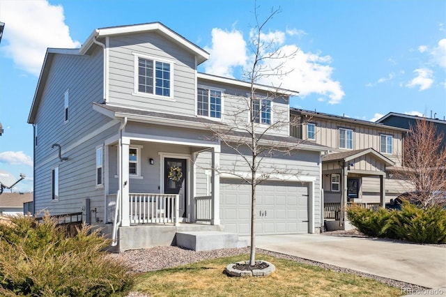 traditional-style house featuring board and batten siding, concrete driveway, an attached garage, and a porch