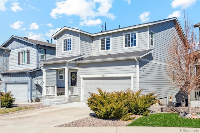 view of front facade featuring an attached garage, a shingled roof, and driveway