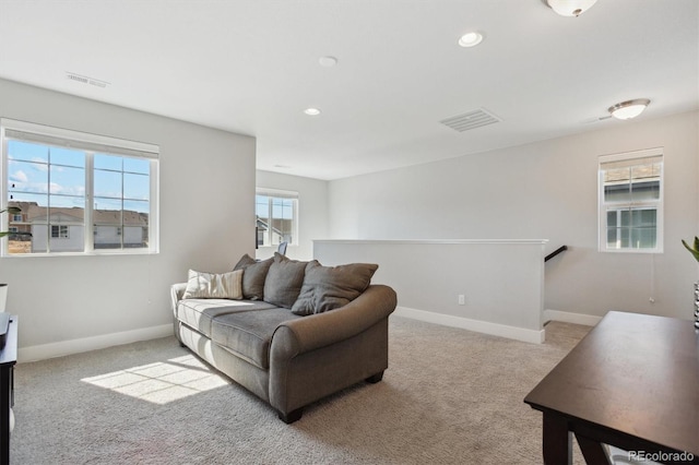 carpeted living room featuring recessed lighting, baseboards, and visible vents