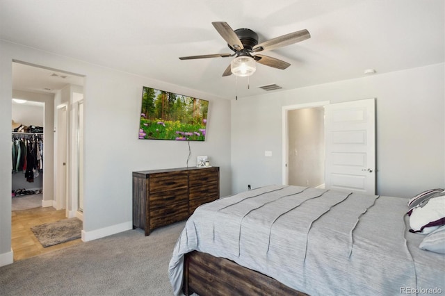 carpeted bedroom featuring baseboards, visible vents, ceiling fan, a spacious closet, and a closet