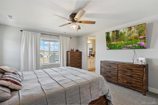 bedroom with visible vents, baseboards, ceiling fan, carpet flooring, and ensuite bathroom