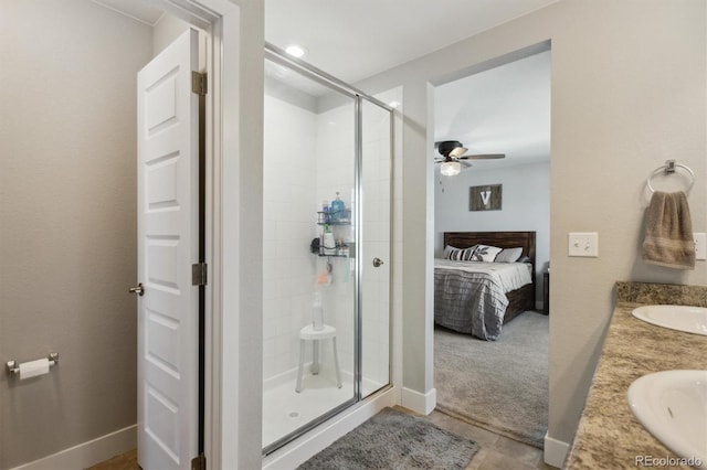 ensuite bathroom featuring a sink, connected bathroom, a stall shower, and ceiling fan