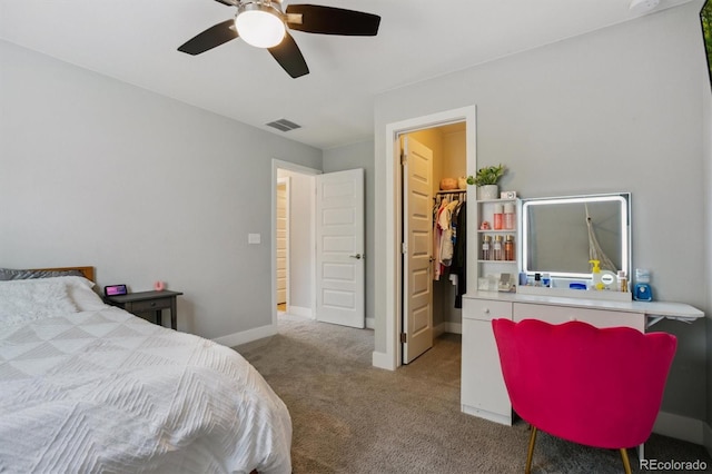 carpeted bedroom with visible vents, a ceiling fan, a closet, baseboards, and a spacious closet