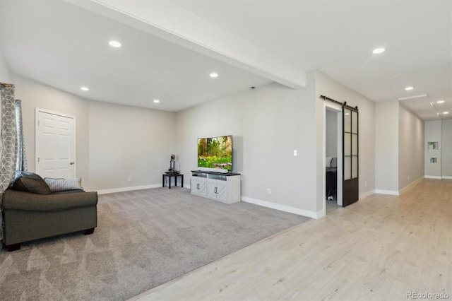 interior space featuring recessed lighting, baseboards, and a barn door