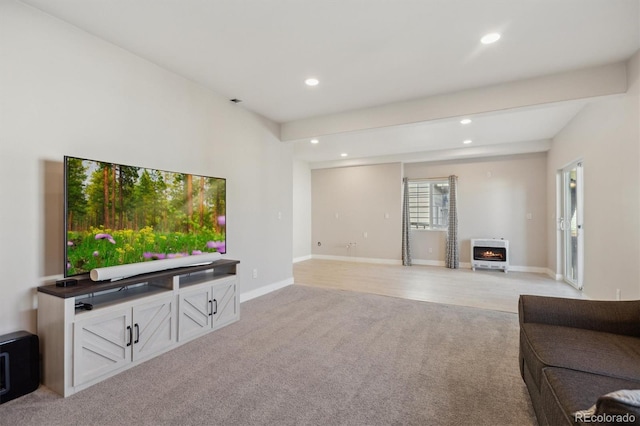 living area with heating unit, recessed lighting, light colored carpet, and baseboards