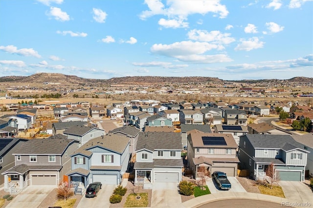 drone / aerial view featuring a residential view and a mountain view