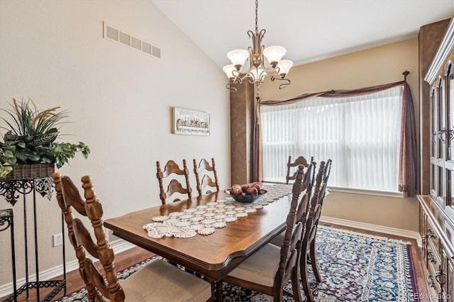 1844 S Jay Way, Lakewood, CO 80232 - dining space with an inviting chandelier, wood finished floors, visible vents, and baseboards