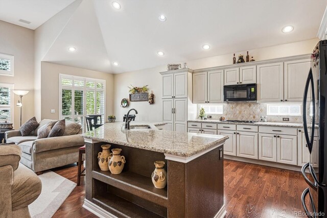 1844 S Jay Way, Lakewood, CO 80232 - kitchen with a sink, open shelves, open floor plan, black appliances, and light stone counters