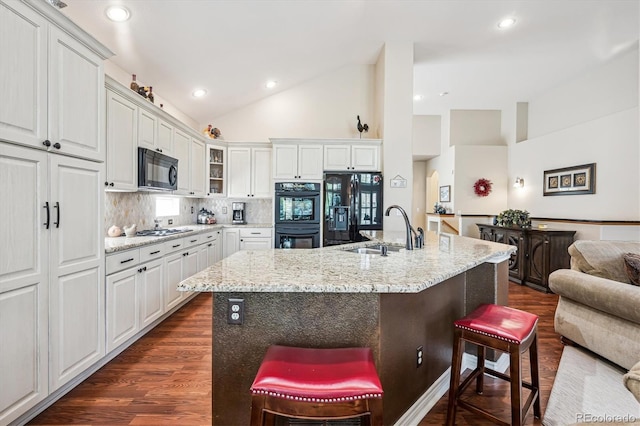 1844 S Jay Way, Lakewood, CO 80232 - kitchen with glass insert cabinets, dark wood-style flooring, a sink, a kitchen breakfast bar, and black appliances