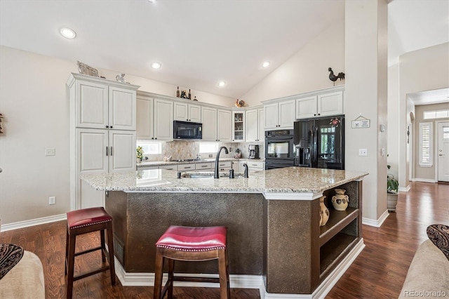 1844 S Jay Way, Lakewood, CO 80232 - kitchen featuring baseboards, black appliances, open shelves, and a sink