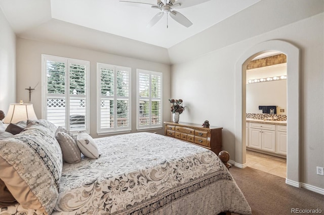 1844 S Jay Way, Lakewood, CO 80232 - bedroom featuring a ceiling fan, baseboards, ensuite bath, arched walkways, and light carpet