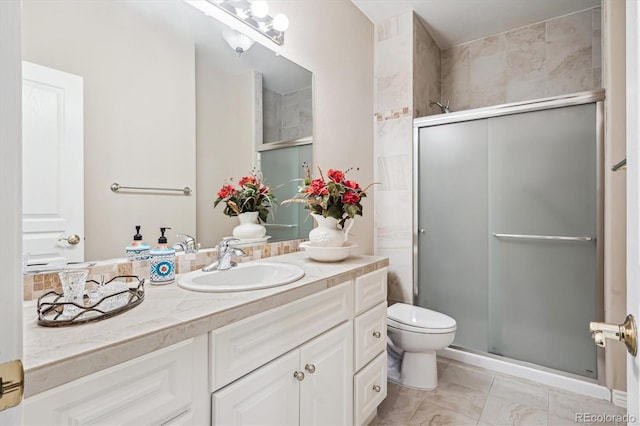 1844 S Jay Way, Lakewood, CO 80232 - full bath with a shower stall, marble finish floor, vanity, and toilet