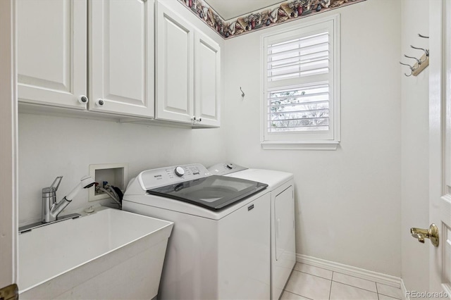 1844 S Jay Way, Lakewood, CO 80232 - clothes washing area with washing machine and dryer, baseboards, light tile patterned flooring, a sink, and cabinet space