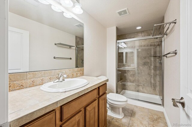 1844 S Jay Way, Lakewood, CO 80232 - full bathroom with vanity, toilet, a shower stall, and visible vents