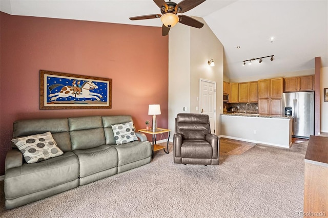 8778 S Kipling Way Unit 304, Littleton, CO 80127 - living area featuring carpet flooring, a ceiling fan, track lighting, lofted ceiling, and baseboards