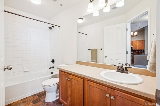 8778 S Kipling Way Unit 304, Littleton, CO 80127 - bathroom featuring shower / bath combination, vanity, toilet, and a chandelier