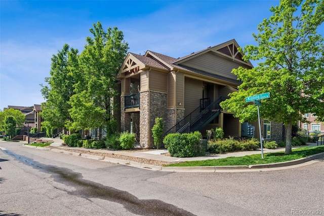 8778 S Kipling Way Unit 304, Littleton, CO 80127 - view of side of home featuring stone siding and stairs