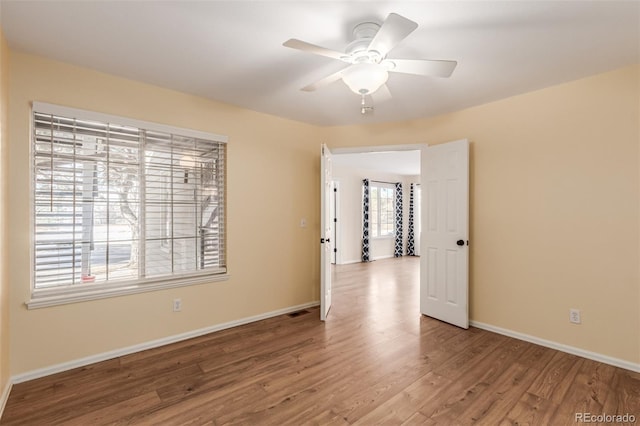 spare room featuring wood-type flooring and ceiling fan