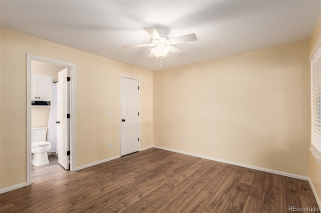 unfurnished bedroom featuring ensuite bath, baseboards, ceiling fan, and wood finished floors