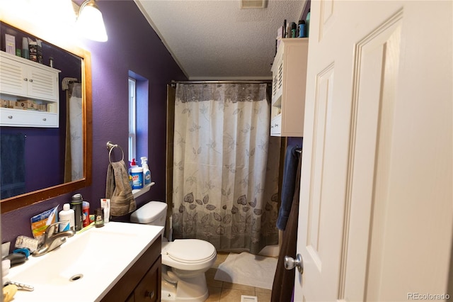 bathroom featuring vanity, toilet, a textured ceiling, walk in shower, and tile patterned flooring