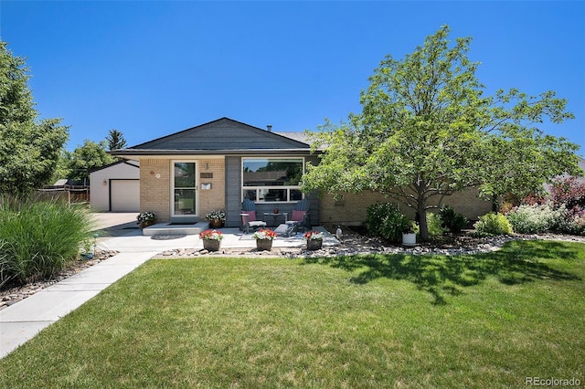 6868 S Birch Way, Centennial, CO 80122 - back of property featuring brick siding, concrete driveway, and a garage