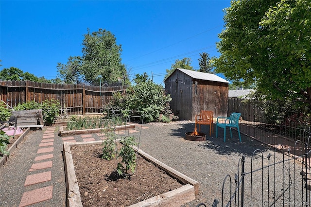 6868 S Birch Way, Centennial, CO 80122 - fenced backyard with a vegetable garden, a storage shed, and an outdoor fire pit