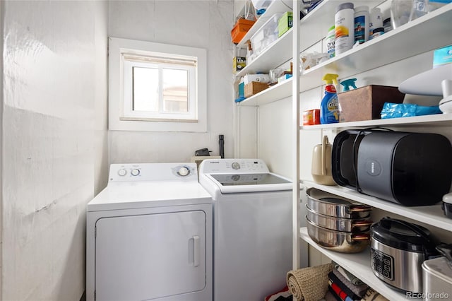 clothes washing area with washing machine and dryer