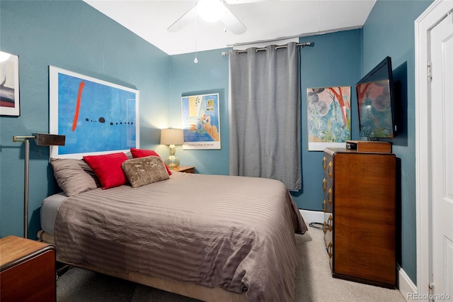 bedroom featuring light carpet and ceiling fan