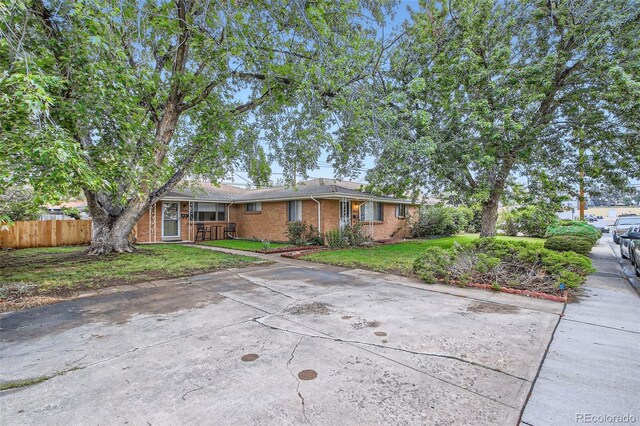 5563 Newland Way, Arvada, CO 80002 - view of front of house with brick siding and concrete driveway