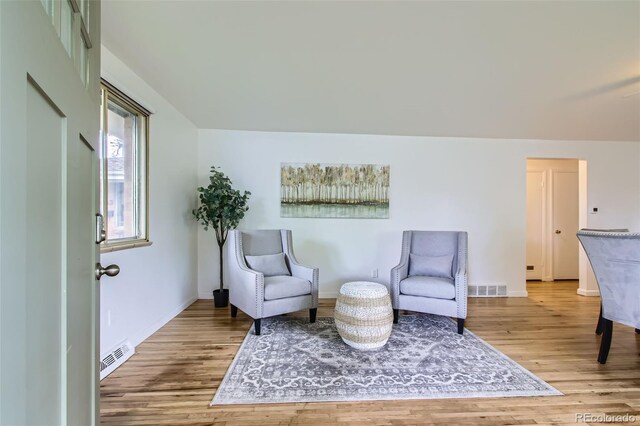 5563 Newland Way, Arvada, CO 80002 - sitting room with wood finished floors and a baseboard heating unit