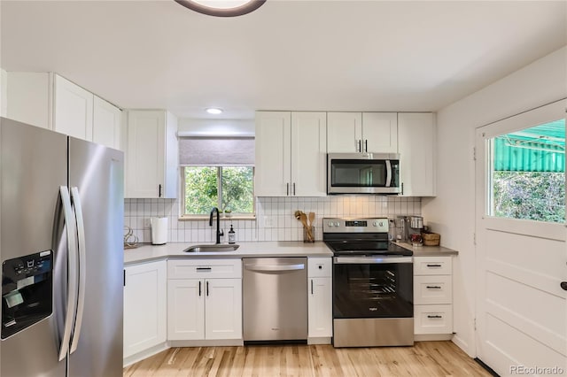 5563 Newland Way, Arvada, CO 80002 - kitchen featuring stainless steel appliances, white cabinetry, backsplash, and recessed lighting