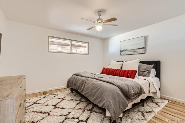 5563 Newland Way, Arvada, CO 80002 - bedroom with wood finished floors and a ceiling fan