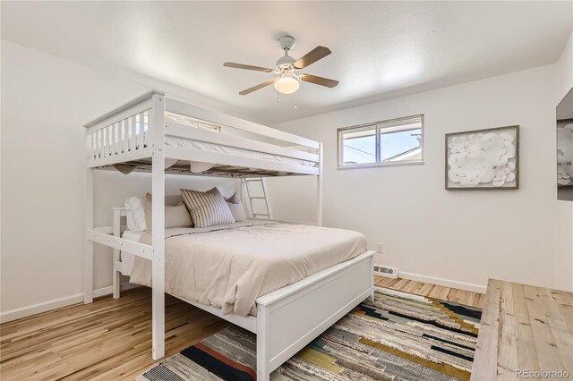 5563 Newland Way, Arvada, CO 80002 - bedroom with wood finished floors and ceiling fan
