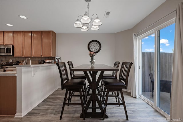 dining area with a chandelier and hardwood / wood-style flooring