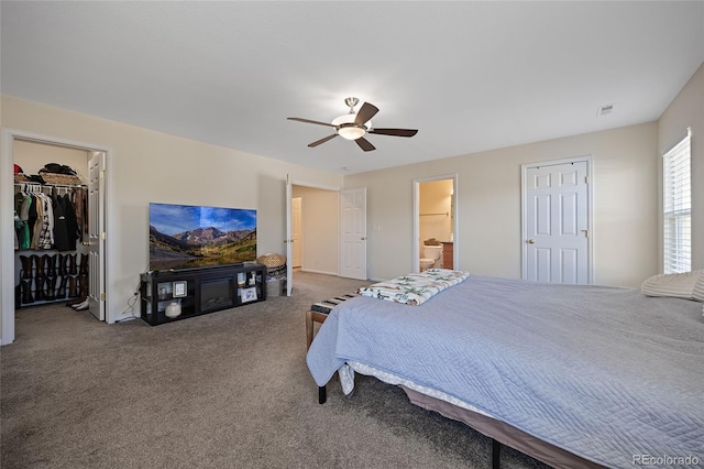 carpeted bedroom with connected bathroom and ceiling fan