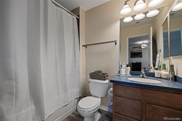 full bathroom featuring ceiling fan, toilet, vanity, shower / tub combo, and hardwood / wood-style flooring