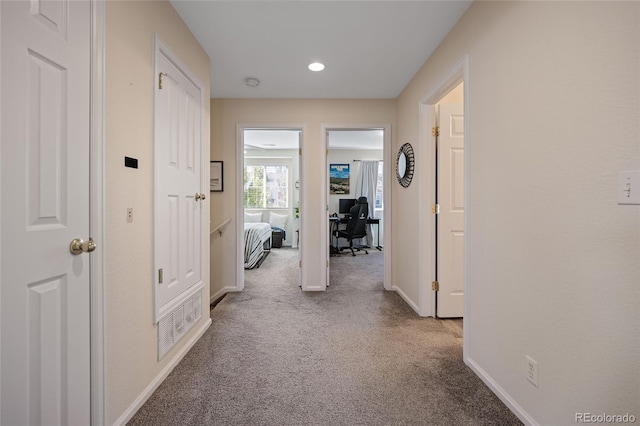 hallway with light carpet