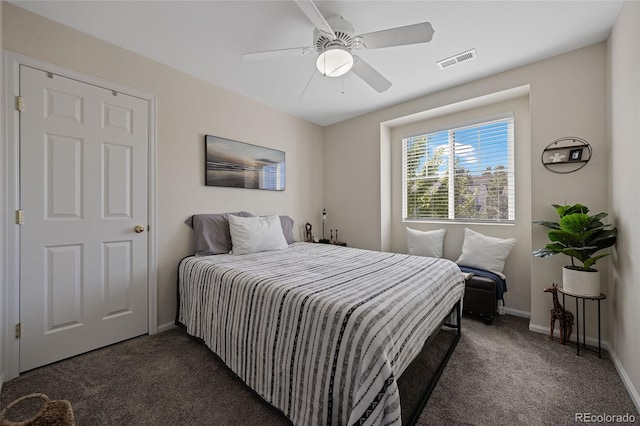 bedroom with dark colored carpet and ceiling fan