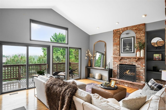 600 Cascade Dr, Golden, CO 80403 - living area with wood finished floors, a brick fireplace, and high vaulted ceiling