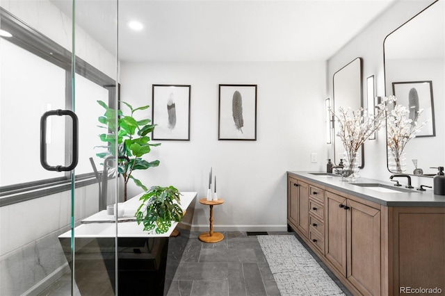 600 Cascade Dr, Golden, CO 80403 - bathroom featuring baseboards, double vanity, a soaking tub, recessed lighting, and a stall shower