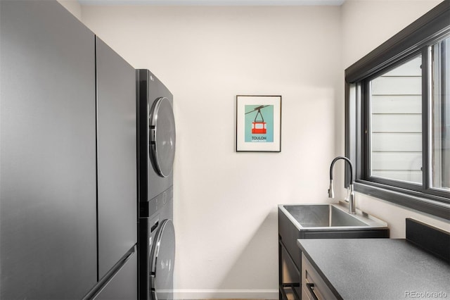 600 Cascade Dr, Golden, CO 80403 - laundry area featuring stacked washer and clothes dryer and cabinet space
