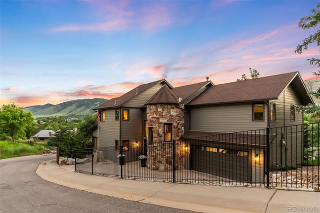 600 Cascade Dr, Golden, CO 80403 - view of front of property with stone siding, a mountain view, and a fenced front yard