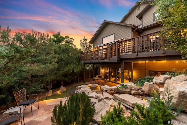 600 Cascade Dr, Golden, CO 80403 - back of house at dusk featuring a patio area, a wooden deck, and an outdoor fire pit