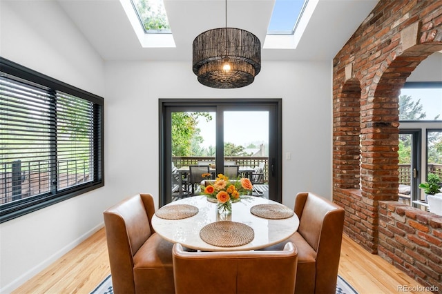 600 Cascade Dr, Golden, CO 80403 - dining space with a skylight, wood finished floors, vaulted ceiling, and arched walkways