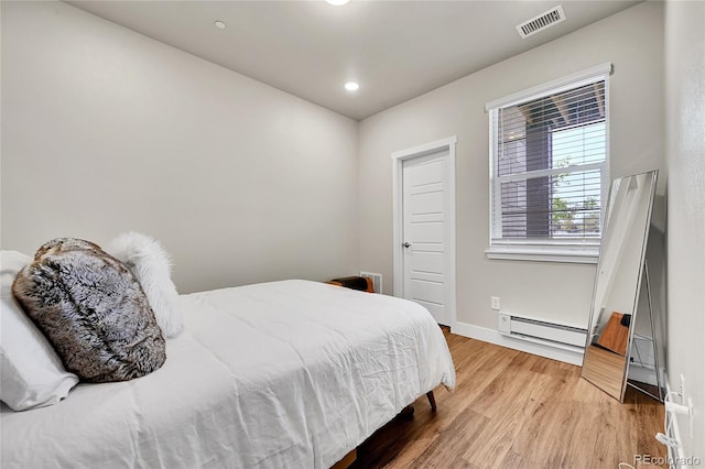 1575 W 68th Ave, Denver, CO 80221 - bedroom with a baseboard heating unit, light wood-style floors, and recessed lighting