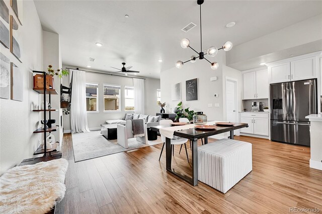 1575 W 68th Ave, Denver, CO 80221 - kitchen featuring stainless steel refrigerator with ice dispenser, white cabinetry, a ceiling fan, open floor plan, and recessed lighting