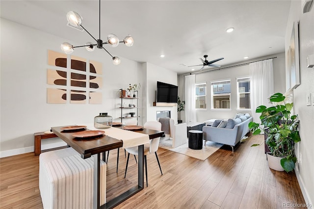 1575 W 68th Ave, Denver, CO 80221 - dining room with light wood-style floors, a ceiling fan, a chandelier, and recessed lighting