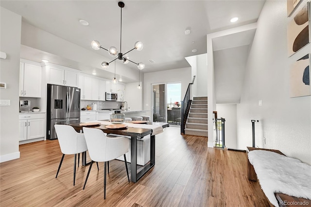1575 W 68th Ave, Denver, CO 80221 - dining room with light wood finished floors, stairway, a chandelier, and recessed lighting