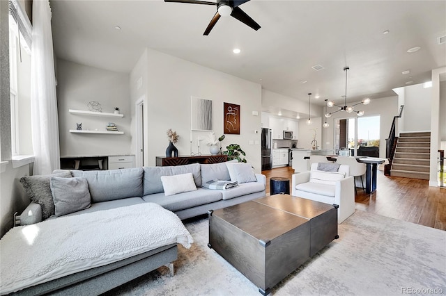 1575 W 68th Ave, Denver, CO 80221 - living room with a ceiling fan, stairs, wood finished floors, recessed lighting, and a chandelier