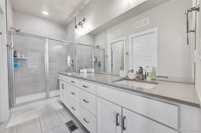 1575 W 68th Ave, Denver, CO 80221 - bathroom with double vanity, a stall shower, recessed lighting, and tile patterned floors
